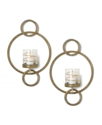 Equal parts wall art and lighting solution, each Symphony Ring sconce by Mikasa glows with whimsical splendor. Featuring rings of goldtone metal and glass candle holders wrapped in shimmering ribbons. Equal parts wall art and lighting solution, each Symphony Ring sconce by Mikasa glows with whimsical splendor. Featuring rings of goldtone metal and glass candle holders wrapped in shimmering ribbons.