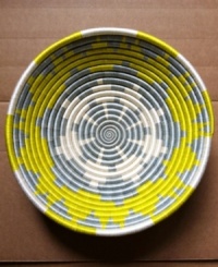 Hope shines among Rwanda's women artisans and in the vivid sun-yellow and slate-blue pattern that distinguishes this handcrafted basket. Filled with fruit or simply accenting a wall, it serves as daily inspiration for women everywhere. Hope shines among Rwanda's women artisans and in the vivid sun-yellow and slate-blue pattern that distinguishes this handcrafted basket. Filled with fruit or simply accenting a wall, it serves as daily inspiration for women everywhere.