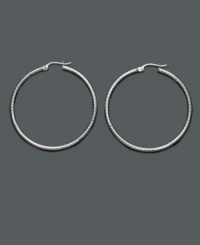 Add a playful touch to your look with fashionable hoops. These sterling silver hoop earrings feature a unique diamond-cut texture will never go out of style! Approximate diameter: 1-1/2 inches. Add a playful touch to your look with fashionable hoops. These sterling silver hoop earrings feature a unique diamond-cut texture will never go out of style! Approximate diameter: 1-1/2 inches.