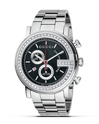 A stainless bracelet watch from the Gucci G Chrono collection. Bezel casing is set with 54 diamonds in the letter G. Round black guilloché dial with stick hour indices. Red sweep second hand and date window. Triple blade deployment buckle. A stainless bracelet watch from the Gucci G Chrono collection. Bezel casing is set with 54 diamonds in the letter G. Round black guilloché dial with stick hour indices. Red sweep second hand and date window. Triple blade deployment buckle.
