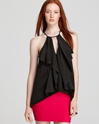 Ruffles cascade around a sexy keyhole cutout on this halter top, bringing a flirty depth to the solid hue. Ruffles cascade around a sexy keyhole cutout on this halter top, bringing a flirty depth to the solid hue.