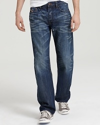 Distressed and faded for a tried-and-true look, with whisker detail on the thigh and back of knee, this modern jean from Diesel puts the cool in casual cool, featuring a relaxed straight leg for your laid-back style. Distressed and faded for a tried-and-true look, with whisker detail on the thigh and back of knee, this modern jean from Diesel puts the cool in casual cool, featuring a relaxed straight leg for your laid-back style.