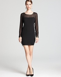 Olive and Oak does basic black with a twist: gilded foil trim adorns the neck and back of this sheer dress for just a touch of modernity. Olive and Oak does basic black with a twist: gilded foil trim adorns the neck and back of this sheer dress for just a touch of modernity.