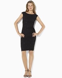 A sleek matte jersey dress is made glamorous with a sequin-and-lace overlay, creating an elegant cocktail silhouette A sleek matte jersey dress is made glamorous with a sequin-and-lace overlay, creating an elegant cocktail silhouette