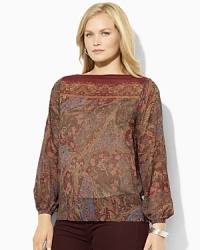 A slightly sheer georgette blouse is rendered with an allover floral pattern, adding feminine allure to any wardrobe.