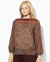 A slightly sheer georgette blouse is rendered with an allover floral pattern, adding feminine allure to any wardrobe. A slightly sheer georgette blouse is rendered with an allover floral pattern, adding feminine allure to any wardrobe.