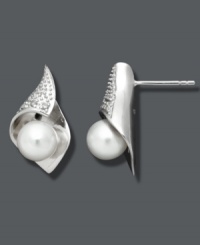 Delicate sophistication. Petite studs make a subtle impact with shimmering cultured freshwater pearls (7-8 mm), sparkling diamond accents, and a polished sterling silver setting. Approximate diameter: 7/8 inch. Delicate sophistication. Petite studs make a subtle impact with shimmering cultured freshwater pearls (7-8 mm), sparkling diamond accents, and a polished sterling silver setting. Approximate diameter: 7/8 inch.