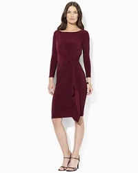 Cascading ruffles and an eye-catching knotted front make this form-fitting matte jersey dress a perfect fit for all occasions. Cascading ruffles and an eye-catching knotted front make this form-fitting matte jersey dress a perfect fit for all occasions.