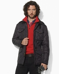 A quilted combat jacket is crafted in a durable fabric and accented with various utility pockets and suede details for a sleek look. A quilted combat jacket is crafted in a durable fabric and accented with various utility pockets and suede details for a sleek look.