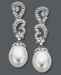 Update your jewelry box with a little glamour. These stunning, swirl-shaped drop earrings are adorned with round-cut diamonds (1/5 ct. t.w.) and cultured freshwater pearl drops (8 mm x 10 mm). Crafted in 14k white gold. Approximate drop: 1-1/4 inches. Update your jewelry box with a little glamour. These stunning, swirl-shaped drop earrings are adorned with round-cut diamonds (1/5 ct. t.w.) and cultured freshwater pearl drops (8 mm x 10 mm). Crafted in 14k white gold. Approximate drop: 1-1/4 inches.