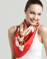 A bright oversized silk scarf featuring an elegant magnolia print and signature logo at hem.