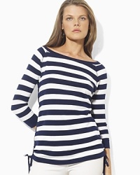 Bold stripes grace the front of a three quarter sleeve tee, crafted with an elegant ballet neckline and drawcord detailing at the hem to create chic ruching. Bold stripes grace the front of a three quarter sleeve tee, crafted with an elegant ballet neckline and drawcord detailing at the hem to create chic ruching.
