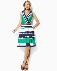 Crisp cotton is tailored in an elegant fit-and-flare silhouette, finished with a chic crossover neckline and belted waist. Crisp cotton is tailored in an elegant fit-and-flare silhouette, finished with a chic crossover neckline and belted waist.