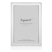 Gleaming sterling silver edged in a delicate beaded pattern forms this classically elegant frame from Argento SC. Gleaming sterling silver edged in a delicate beaded pattern forms this classically elegant frame from Argento SC.