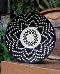 Amazingly handcrafted in all-natural fibers, the Imvura basket is woven with a distinct pattern that flows from its center and represents the life-giving rains in Africa. The contrast between black and sisal make it well suited for any living space. Amazingly handcrafted in all-natural fibers, the Imvura basket is woven with a distinct pattern that flows from its center and represents the life-giving rains in Africa. The contrast between black and sisal make it well suited for any living space.