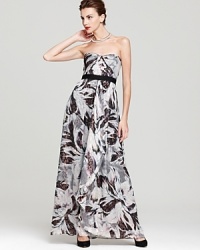 A floral print with shimmering metallic accents is showcased on a strapless silhouette from BCBGMAXAZRIA. A floral print with shimmering metallic accents is showcased on a strapless silhouette from BCBGMAXAZRIA.