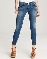 A subtly cropped silhouette makes these artfully faded Hudson skinny jeans the perfect pair for balmy-season style. A subtly cropped silhouette makes these artfully faded Hudson skinny jeans the perfect pair for balmy-season style.