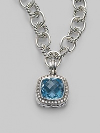 A sparkling faceted blue topaz, surrounded by pavé diamonds, sits in a squared setting of sterling silver with a cabled edge and fluted bale. Blue topaz Diamonds, 0.45 tcw Sterling silver with a black rhodium finish About ¾ square Spring clip clasp Made in USA Please note: Necklace sold separately.