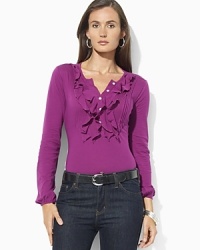 A long-sleeved cotton tee is accented with delicate ruffles at the placket for a feminine twist on a classic. A long-sleeved cotton tee is accented with delicate ruffles at the placket for a feminine twist on a classic.