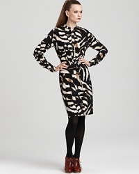 Look ravishing in this Calvin Klein henley dress, invigorated in an abstract black-and-white print that encourages colorful statement pumps to pop. Look ravishing in this Calvin Klein henley dress, invigorated in an abstract black-and-white print that encourages colorful statement pumps to pop.