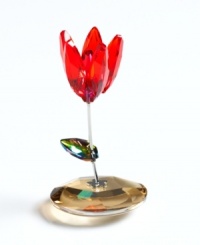 This cherry-red tulip rocks in the breeze, rooted in a faceted crystal disc. A multicolored leaf sprouts from a simple, silvertone stem. From Swarovski. This cherry-red tulip rocks in the breeze, rooted in a faceted crystal disc. A multicolored leaf sprouts from a simple, silvertone stem. From Swarovski.