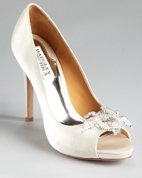 In white satin, Badgley Mischka's Reta pumps are a dream come true for brides to be. Delicate lace and crystal detailing lends a glamorous touch. In white satin, Badgley Mischka's Reta pumps are a dream come true for brides to be. Delicate lace and crystal detailing lends a glamorous touch.