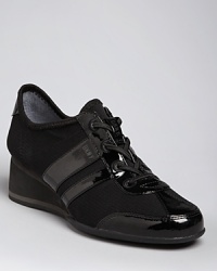 DKNY always delivers looks in step with the athletic trend; these sneakers take things up a notch on wedge heels. DKNY always delivers looks in step with the athletic trend; these sneakers take things up a notch on wedge heels.