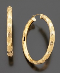 Regal 14k gold hoops with elegant diamond-cut accents. Approximate diameter: 1-1/2 inches. Regal 14k gold hoops with elegant diamond-cut accents. Approximate diameter: 1-1/2 inches.