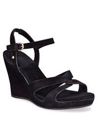 Soft suede straps, twisted at the toe and buckled at the ankle, perch on a comfortable wedge. Soft suede straps, twisted at the toe and buckled at the ankle, perch on a comfortable wedge.