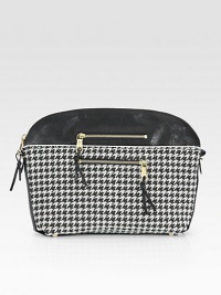 Graphic houndstooth fabric with leather trim and goldtone hardware.Top zip closureProtective metal feetTwo outside zip pocketsTwo inside open pocketsCotton lining14½W X 10½H X 3¼DMade in Italy