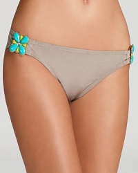 Turquoise-colored, jewelry style accents give this Trina Turk bikini bottom a retro-luxe aesthetic. Turquoise-colored, jewelry style accents give this Trina Turk bikini bottom a retro-luxe aesthetic.