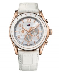 Everyday elegance, by Tommy Hilfiger. Watch crafeted of white croc-embossed leather strap and round rose-gold-plated stainless steel case. White bezel with rose-gold tone logo detail. Mother-of-pearl chronograph dial features rose-gold tone numerals and stick indices at markers, three subdials, luminous hands, and iconic flag logo at twelve o'clock. Quartz movement. Water resistant to 50 meters. Ten-year limited warranty. Everyday elegance, by Tommy Hilfiger. Watch crafeted of white croc-embossed leather strap and round rose-gold-plated stainless steel case. White bezel with rose-gold tone logo detail. Mother-of-pearl chronograph dial features rose-gold tone numerals and stick indices at markers, three subdials, luminous hands, and iconic flag logo at twelve o'clock. Quartz movement. Water resistant to 50 meters. Ten-year limited warranty.