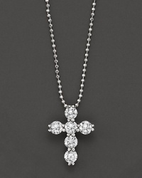 Diamond cross pendant in white gold formed from a gleaming cluster of orbs, with ball chain. Diamond cross pendant in white gold formed from a gleaming cluster of orbs, with ball chain.