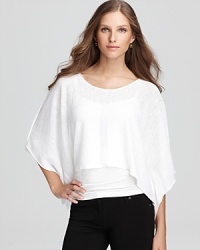 There's fresh energy in a linen Eileen Fisher poncho billowing with effortless dolman sleeves and an angled silhouette for a modern bohemian vision. There's fresh energy in a linen Eileen Fisher poncho billowing with effortless dolman sleeves and an angled silhouette for a modern bohemian vision.