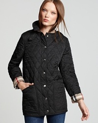 The cornerstone to any outerwear repertoire, this lightweight Burberry Brit jacket transitions into the new season with a classic quilted silhouette and iconic check lining. The cornerstone to any outerwear repertoire, this lightweight Burberry Brit jacket transitions into the new season with a classic quilted silhouette and iconic check lining.