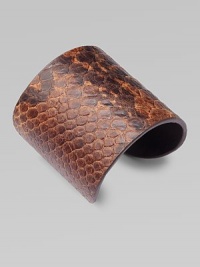 This lovely, python-print style feature a wide design for an impactful look. Python-print leatherMetal baseDiameter, about 2½Slip-on styleImported 