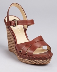 A lace-up inspired detail around the midsole adds a unique touch to Enzo Angiolini's Greyti sandal, boasting a textured wedge heel as a final finishing touch. A lace-up inspired detail around the midsole adds a unique touch to Enzo Angiolini's Greyti sandal, boasting a textured wedge heel as a final finishing touch.