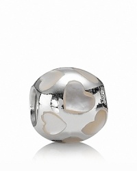 Sterling silver serves as polished backdrop to sweet heart motifs in white mother-of-pearl. Charm by PANDORA. Sterling silver serves as polished backdrop to sweet heart motifs in white mother-of-pearl. Charm by PANDORA.
