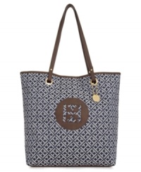 Find your signature style with this iconic design from Tommy Hilfiger. An all-over logo print decorates this take-anywhere tote silhouette, while polished goldtone hardware and contrast trim provide the perfect finishing touches. Find your signature style with this iconic design from Tommy Hilfiger. An all-over logo print decorates this take-anywhere tote silhouette, while polished goldtone hardware and contrast trim provide the perfect finishing touches.