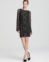 Pleated bell sleeves lend a 60's inspired feel to Laundry by Shelli Segal's metallic lace dress. Pleated bell sleeves lend a 60's inspired feel to Laundry by Shelli Segal's metallic lace dress.