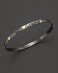 A beautiful bangle from Gurham, crafted with hammered dark silver with 24 Kt. yellow gold stud accents.