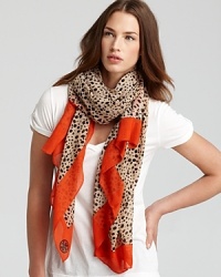 Wild yet mild, this stylish Tory Burch scarf mixes a subdued cheetah print with a bold red border. Wild yet mild, this stylish Tory Burch scarf mixes a subdued cheetah print with a bold red border.