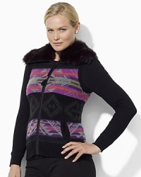Rendered in a vibrant Fair Isle pattern, a cozy sweater vest is finished with luxe faux fur at the collar. Rendered in a vibrant Fair Isle pattern, a cozy sweater vest is finished with luxe faux fur at the collar.