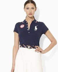 An iconic polo shirt is crafted in a slim stretch silhouette from breathable cotton mesh and accented with bold country embroidery to celebrate Team USA's participation in the 2012 Olympics. An iconic polo shirt is crafted in a slim stretch silhouette from breathable cotton mesh and accented with bold country embroidery to celebrate Team USA's participation in the 2012 Olympics.