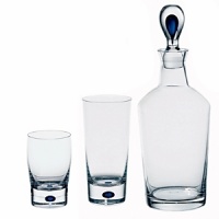 The Intermezzo Blue barware features a dramatic teardrop of blue in the base. Designed by Erika Lagerbielke . Shown from left to right - double old fashion, tumbler, decanter. Also available but not shown: wine carafe. The Intermezzo Blue barware features a dramatic teardrop of blue in the base. Designed by Erika Lagerbielke . Shown from left to right - double old fashion, tumbler, decanter. Also available but not shown: wine carafe.