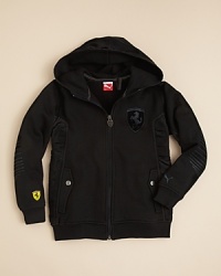A more structured and modern vision of the classic hoodie, the sporty Ferrari jacket from PUMA features pieced contoured panels with sateen trim rendered in a cool tonal palette. A more structured and modern vision of the classic hoodie, the sporty Ferrari jacket from PUMA features pieced contoured panels with sateen trim rendered in a cool tonal palette.