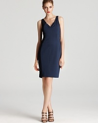 Elie Tahari practices forward-thinking with this futuristic two-tone dress--asymmetric details and a sleek, modern silhouette lend fashion-forward chic. Elie Tahari practices forward-thinking with this futuristic two-tone dress--asymmetric details and a sleek, modern silhouette lend fashion-forward chic.