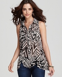 Make a statement this season in a GUESS sleeveless button-up top, imbued with a boldly eclectic print. Make a statement this season in a GUESS sleeveless button-up top, imbued with a boldly eclectic print.