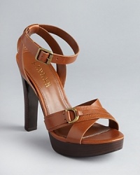 Timeless yet directional, Lauren Ralph Lauren has given these lofty platform sandals an equestrian aesthetic. Timeless yet directional, Lauren Ralph Lauren has given these lofty platform sandals an equestrian aesthetic.