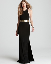 In a minimalistic silhouette, ABS by Allen Schwartz's tank gown lends a modern look with a dramatic T back. A metallic belt subtly accessorizes. In a minimalistic silhouette, ABS by Allen Schwartz's tank gown lends a modern look with a dramatic T back. A metallic belt subtly accessorizes.